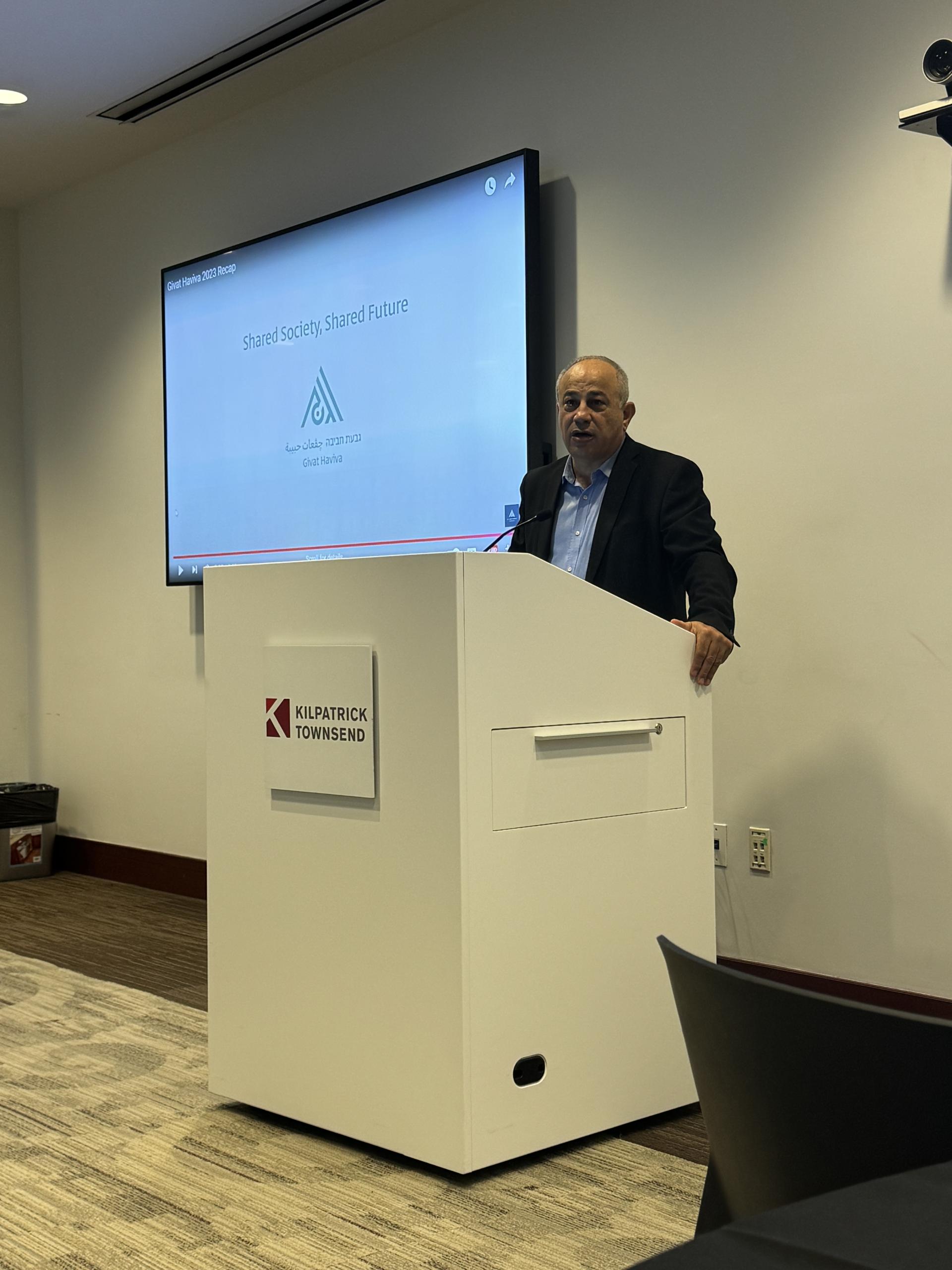 Mohammad Standing behind a podium speaking