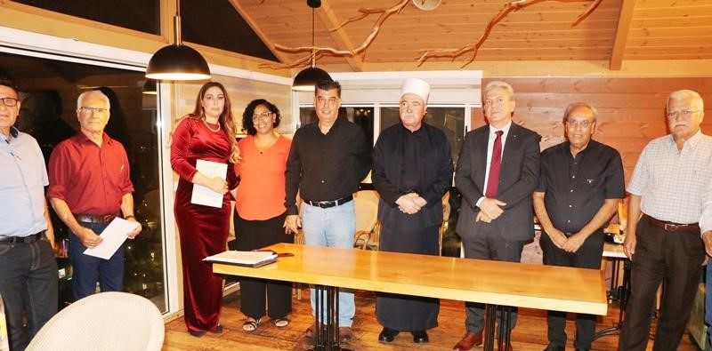a group of mediators standing around a table holding their diplomas