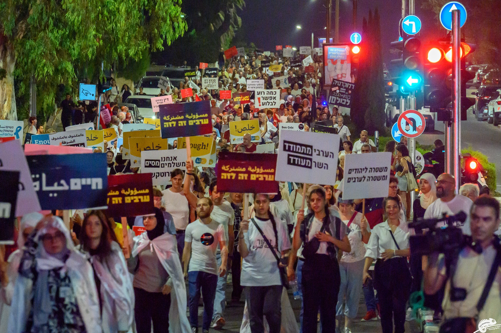 Protesters filling the streets holding signs and marching