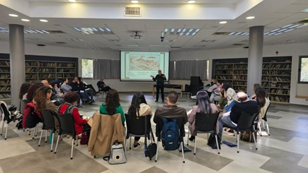 Students facing a powerpoint with an instructor teaching them