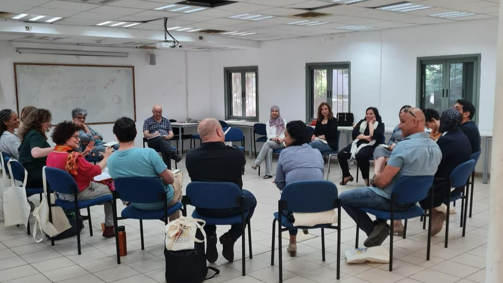 Adults sitting in circle at leadership course