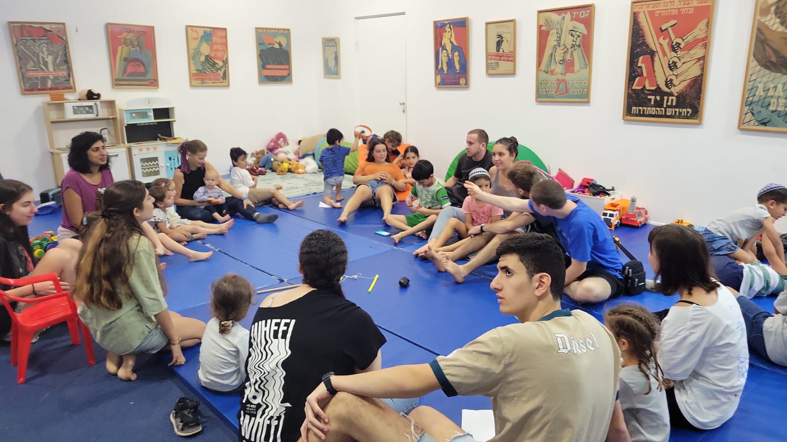 Group of youth sitting on mat on floor