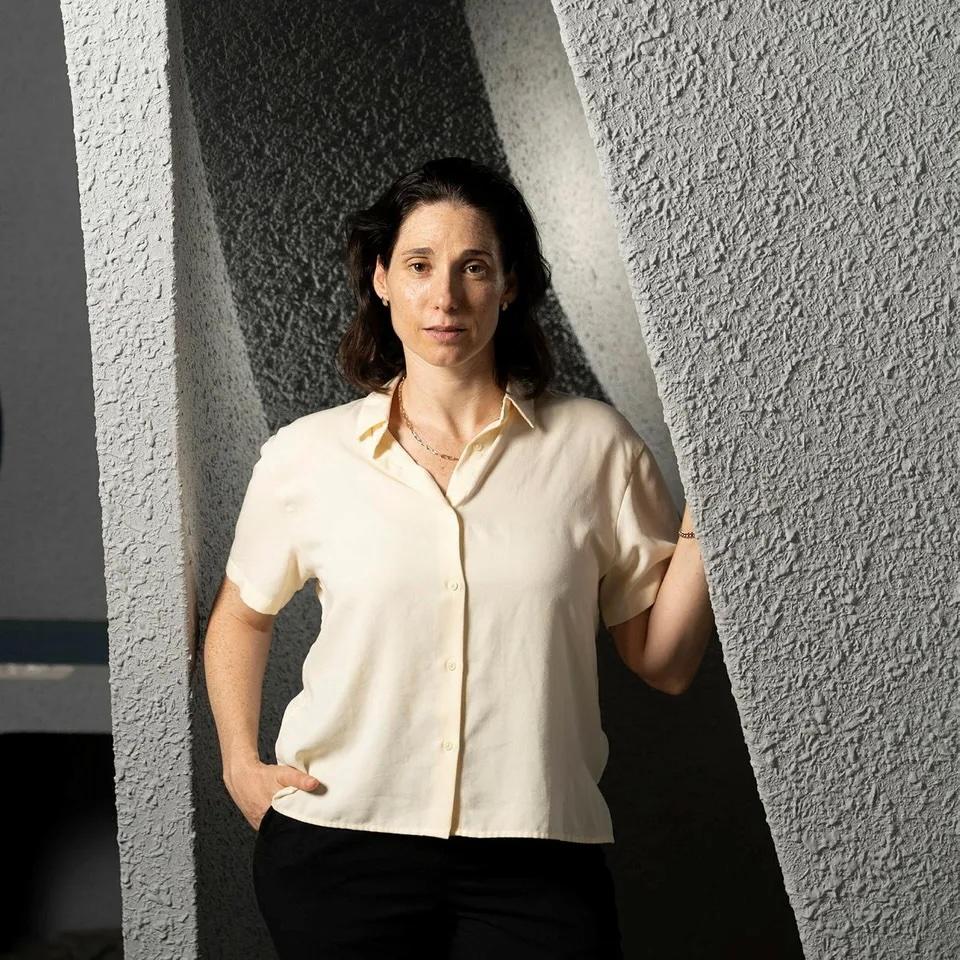 Michal Sella, CEO standing next to a grey wall