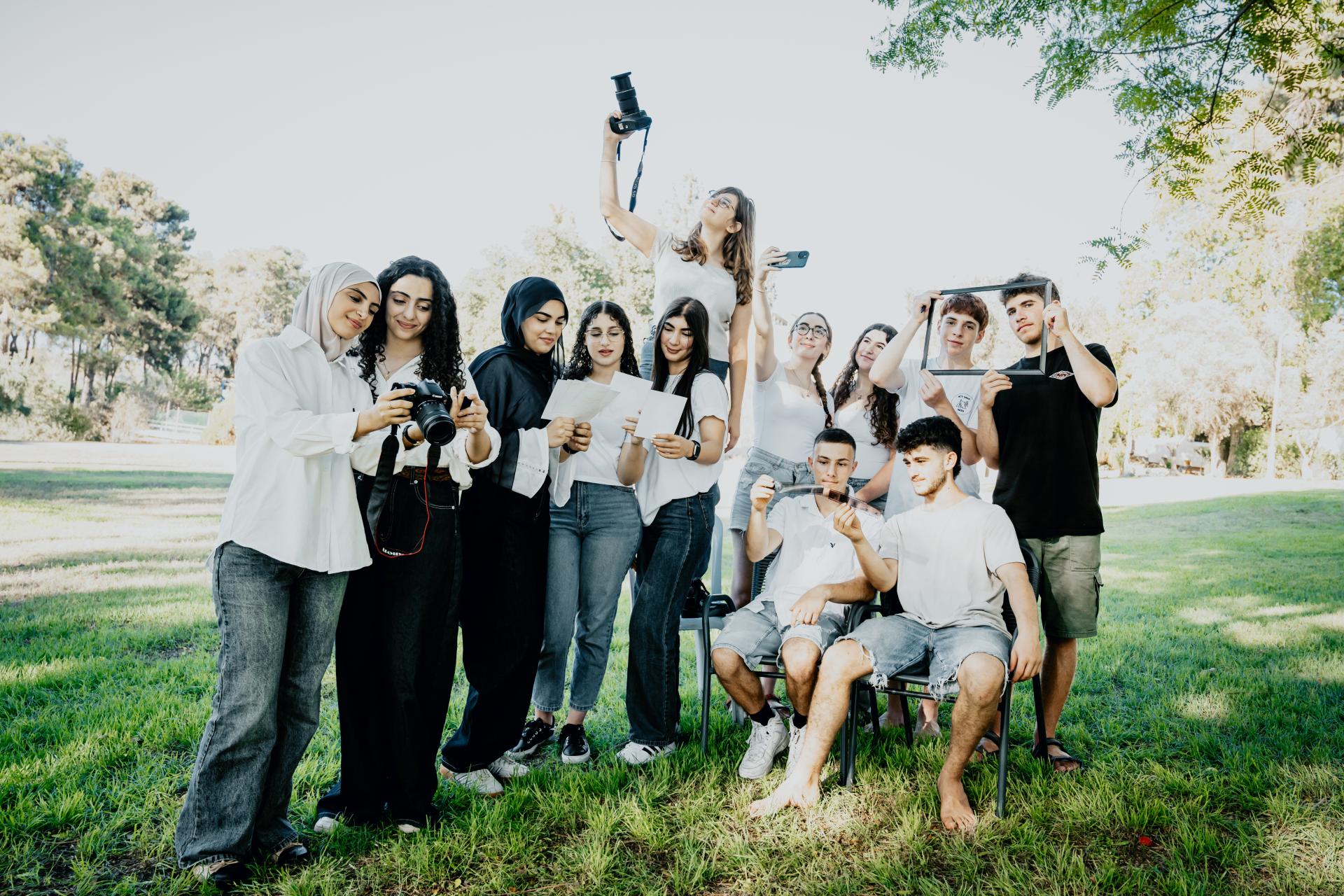 Through Others Eyes program students all standing around looking at cameras