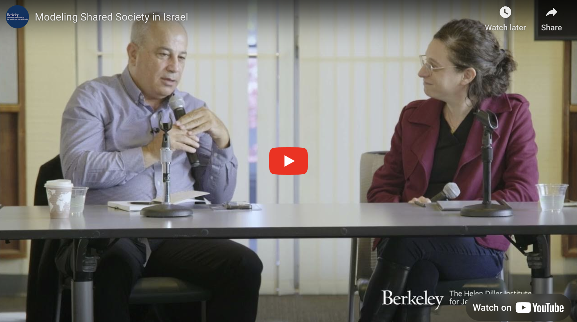 Thumbnail of youtube video where Mohammad is sitting at a table with a microphone and talking to a woman with brown hair